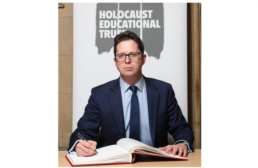 Alex Burghart MP signs the Holocaust Educational Trust's Book of Commitment