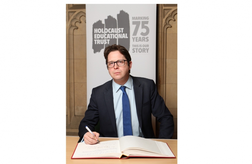 Alex Burghart signs the Holocaust Book of Remembrance